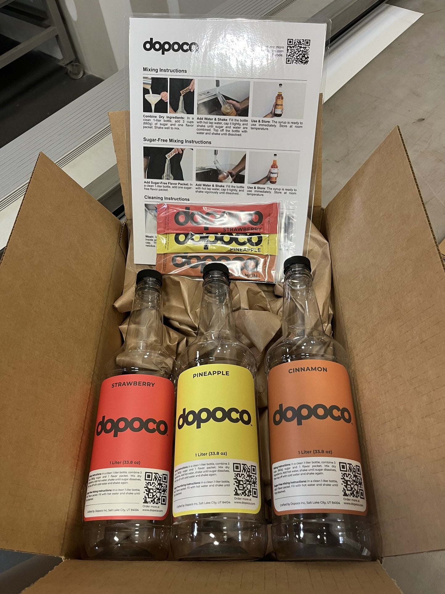 Three Dopoco bottles in a cardboard box with product packaging and instructions.