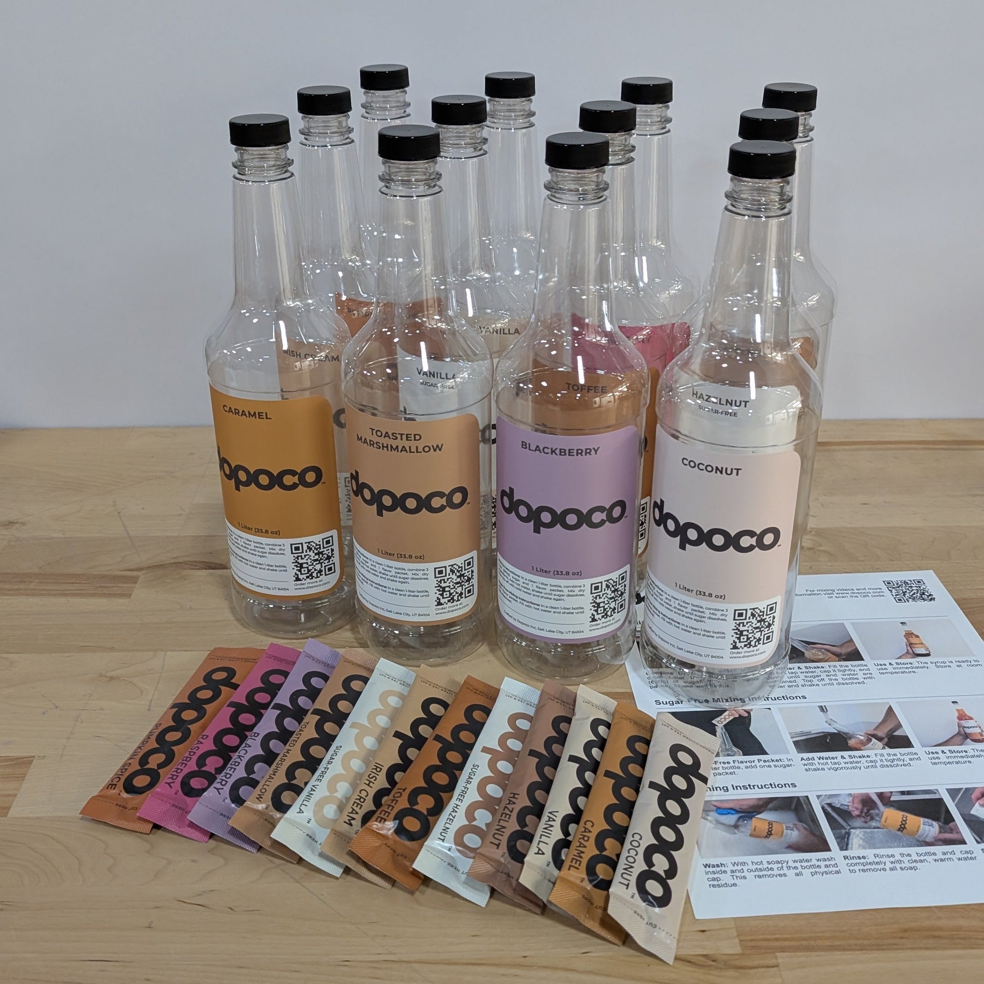 Row of dopoco bottles on a wooden table with colorful labels and a mixing instructions card.
