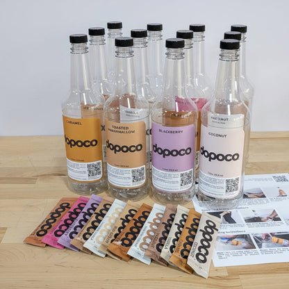Row of dopoco bottles on a wooden table with colorful packets and a leaflet.