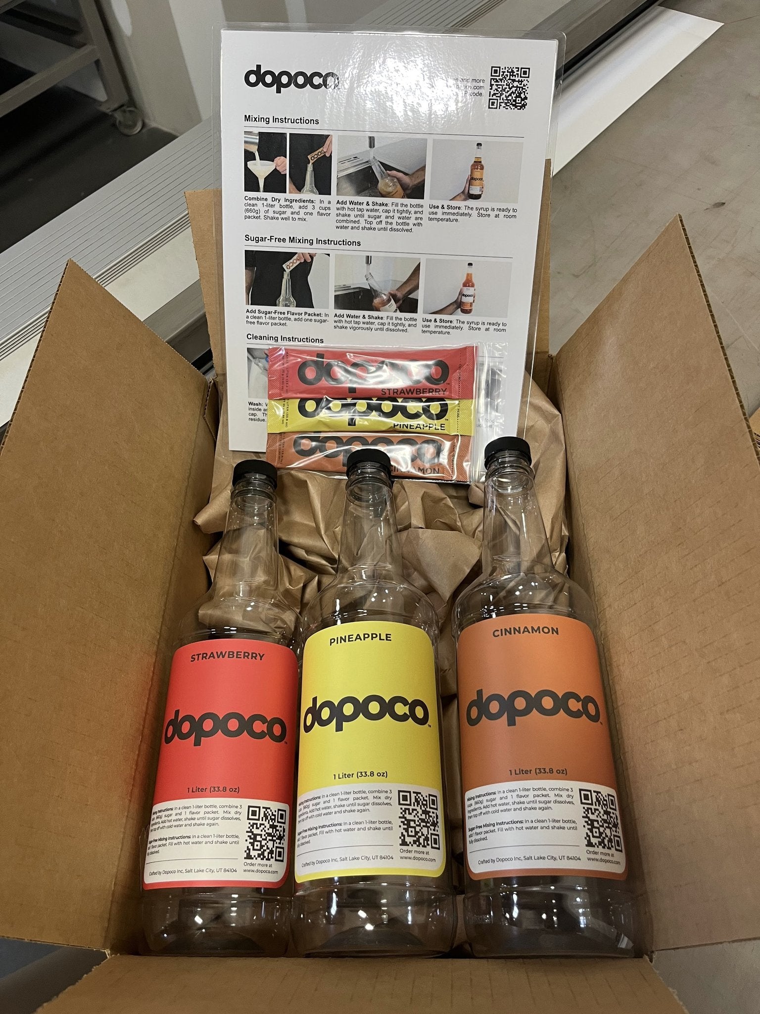 Three Dopoco bottles in a cardboard box with product packaging and instructions.